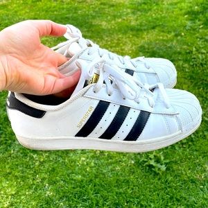 Adidas superstar shoes in cloud white/core black stripes/ cloud white.